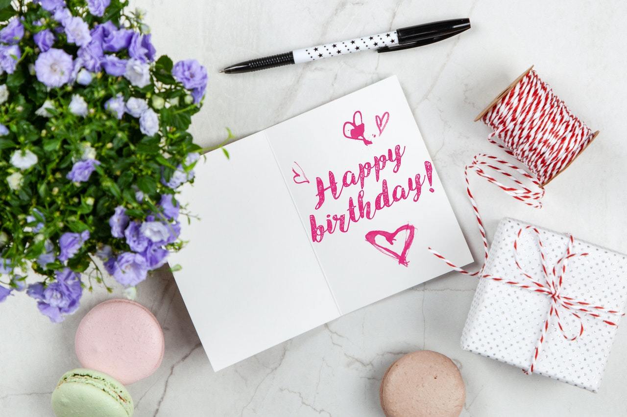 Birthday card with flowers and pastry box